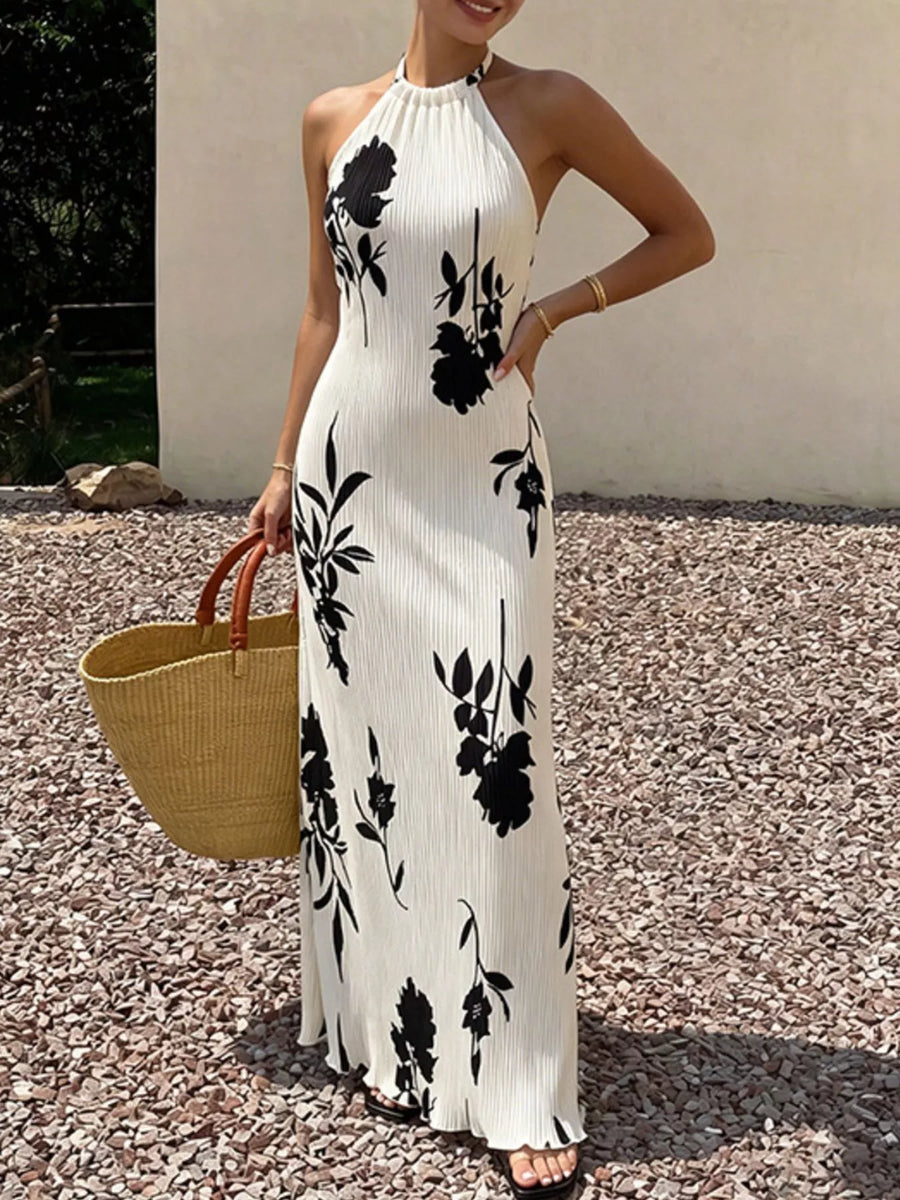 Front view of the White Floral Print Halter Neck Maxi Dress, styled with feminine boutique styling for dinners, travel, and events, made for women who want elegant styling.