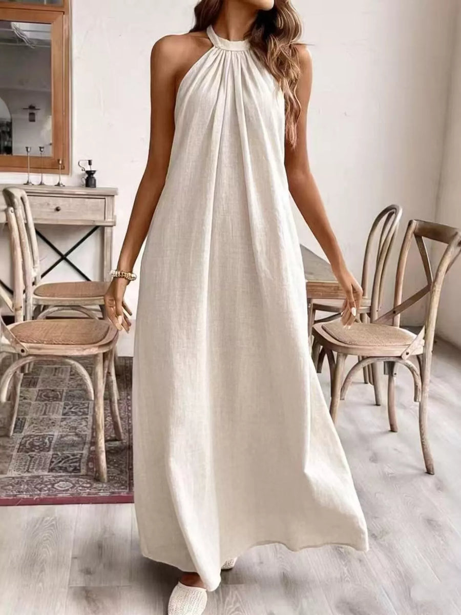 Front view of the Cream White Halter Neck Maxi Dress, styled with feminine boutique styling for dinners, travel, and events, made for women who want elegant styling.