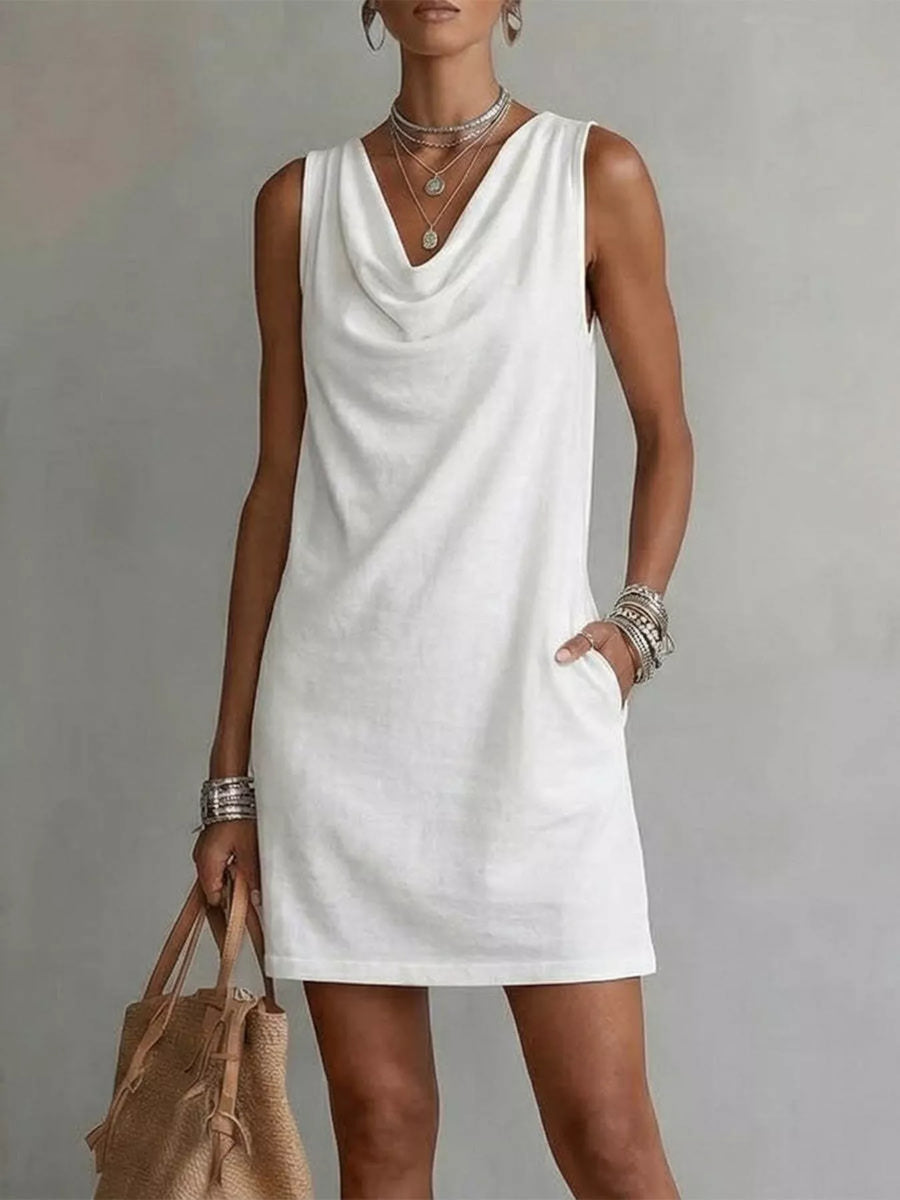 Front view of the White Sleeveless Cowl Neck Mini Dress, styled with feminine boutique styling for dinners, travel, and events, made for women who want elegant styling.
