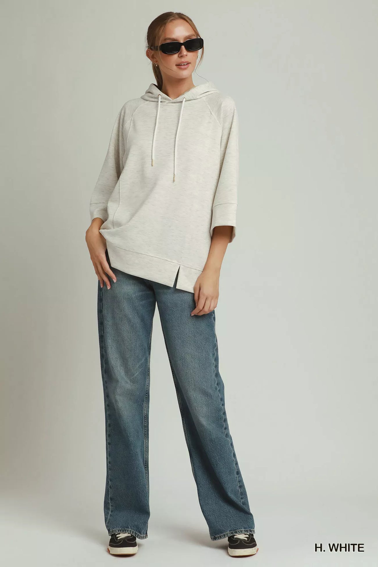Neckline detail of the H. WHITE Umgee 3/4 Sleeve Tunic Top with Graphic Hoodie, styled with polished boutique styling for day-to-night outfits, made for women who want easy layering.