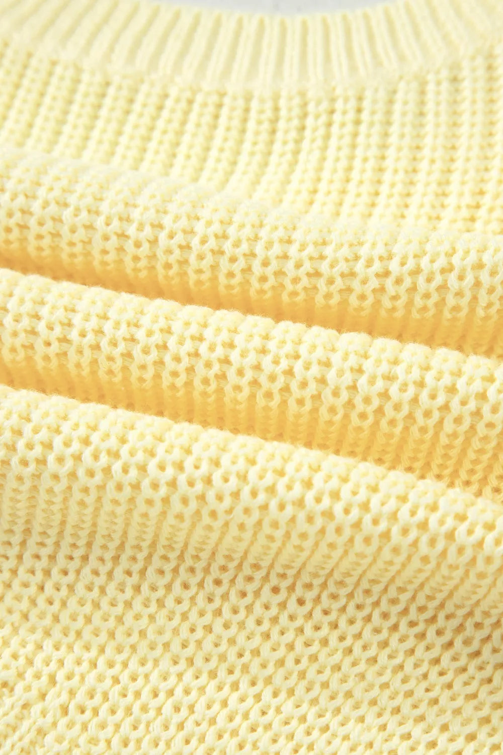 Neckline detail of the Light Yellow Solid Color Cropped Knit Knot Back Cutout Sweater Tank, styled with polished boutique styling for day-to-night outfits, made for women who want easy layering.