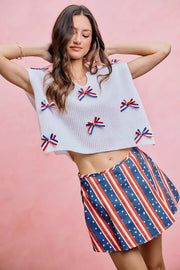 Neckline detail of the OFF WHITE SO ME 4th Of July Ribbon Trimmed Dolman Sweater Top, styled with polished boutique styling for day-to-night outfits, made for women who want easy layering.