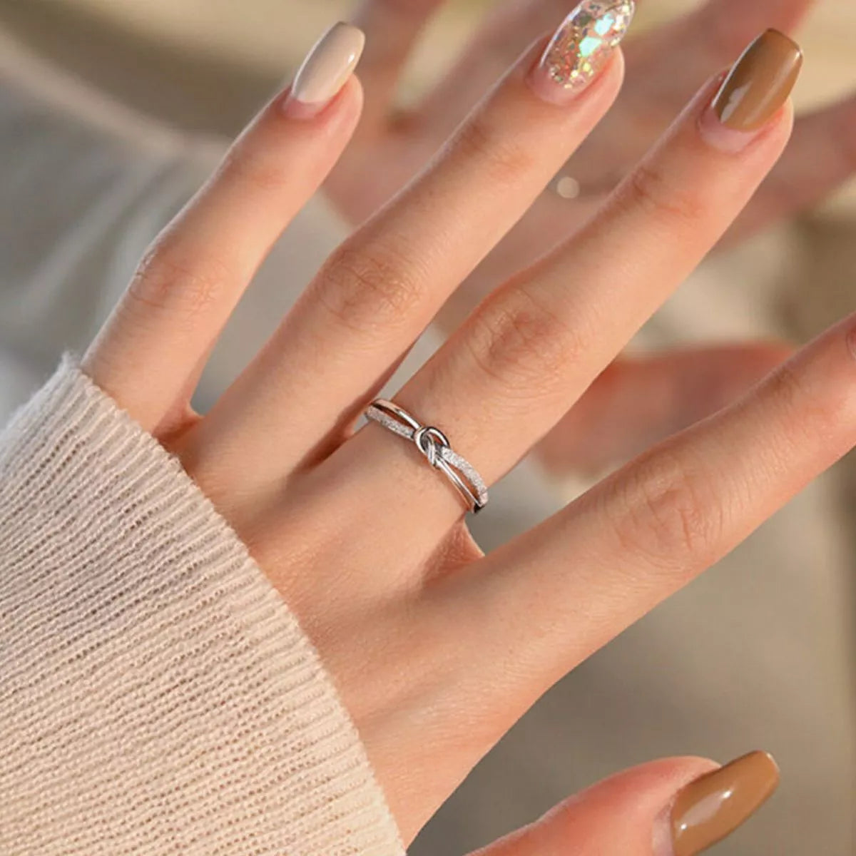 Close-up detail of the Women's Silver Minimalist 925 Sterling Knot Ring for Everyday Styling & Gifting, styled with delicate sparkle for daily wear and gifting, made for women who want refined jewelry.