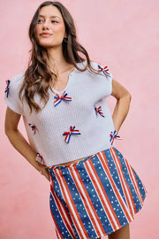 Neckline detail of the OFF WHITE SO ME 4th Of July Ribbon Trimmed Dolman Sweater Top, styled with polished boutique styling for day-to-night outfits, made for women who want easy layering.