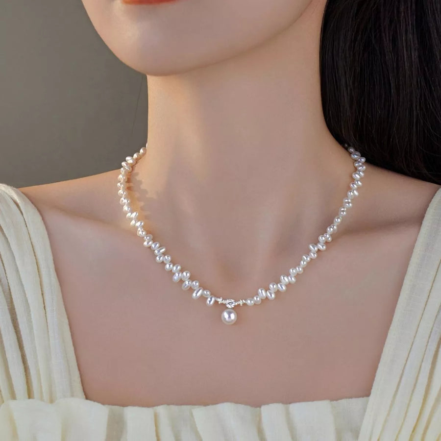 Front view of the White Pearl Necklace, styled with layered jewelry for everyday styling and gifting, made for women who want refined neckline detail.