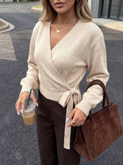Neckline detail of the Apricot Tied Surplice Long Sleeve Sweater, styled with polished boutique styling for day-to-night outfits, made for women who want easy layering.