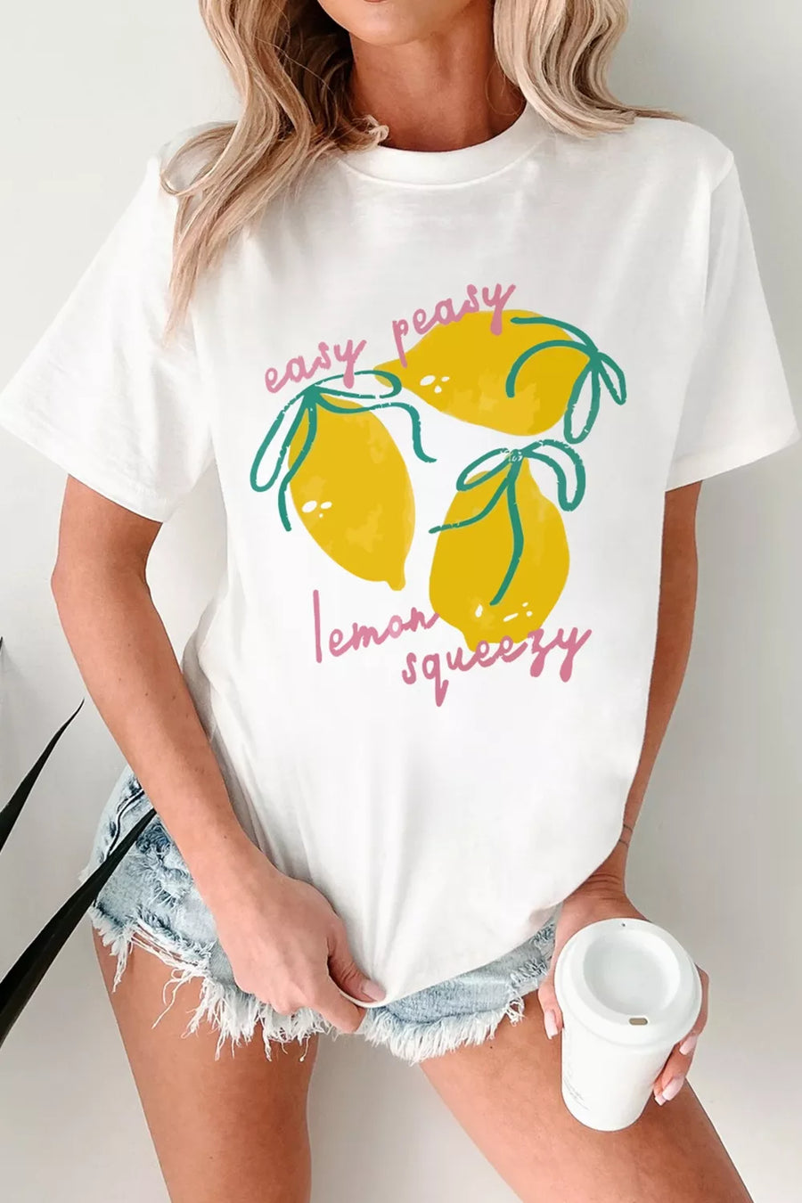 Front view of the White Easy Peasy Lemon Squeezy Graphic Tee, styled with polished boutique styling for day-to-night outfits, made for women who want easy layering.