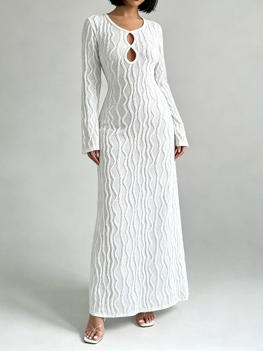 Front view of the White Textured Cut-Out Long Sleeve Maxi Dress, styled with feminine boutique styling for dinners, travel, and events, made for women who want elegant styling.