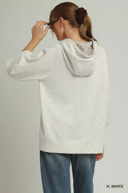 Back view of the H. WHITE Umgee 3/4 Sleeve Tunic Top with Graphic Hoodie, styled with polished boutique styling for day-to-night outfits, made for women who want easy layering.