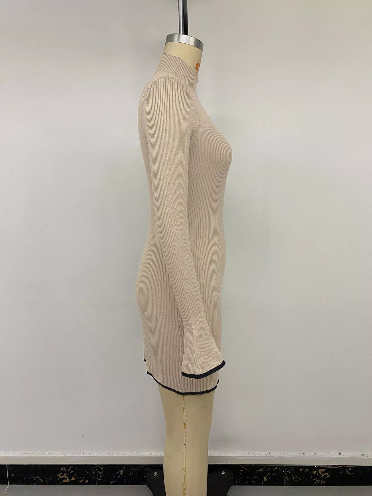 Full-length view of the Khaki Ribbed Mock Neck Flare Sleeve Sweater Dress, styled with feminine boutique styling for dinners, travel, and events, made for women who want elegant styling.