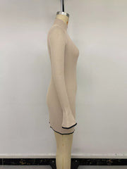 Full-length view of the Khaki Ribbed Mock Neck Flare Sleeve Sweater Dress, styled with feminine boutique styling for dinners, travel, and events, made for women who want elegant styling.