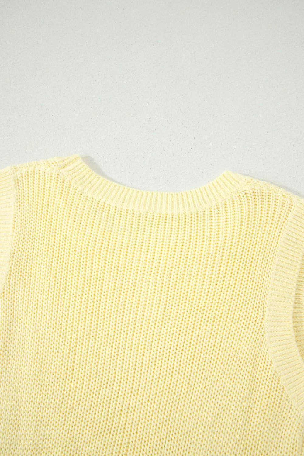 Front view of the Light Yellow Solid Color Cropped Knit Knot Back Cutout Sweater Tank, styled with polished boutique styling for day-to-night outfits, made for women who want easy layering.