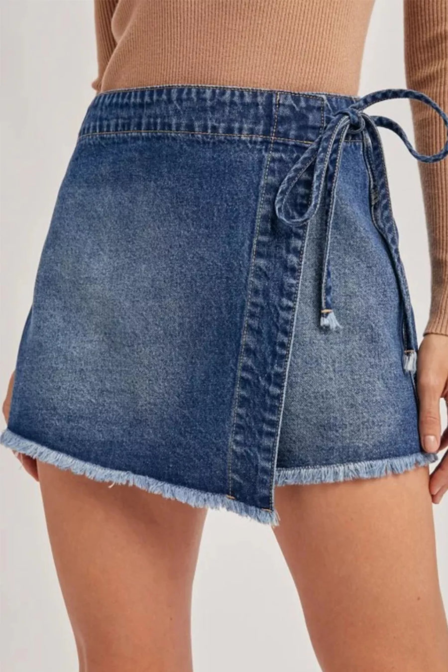 Front view of the Medium Wrapped Tied Waist Denim Skort, styled with polished comfort for work, travel, and everyday wear, made for women who want repeat outfit options.
