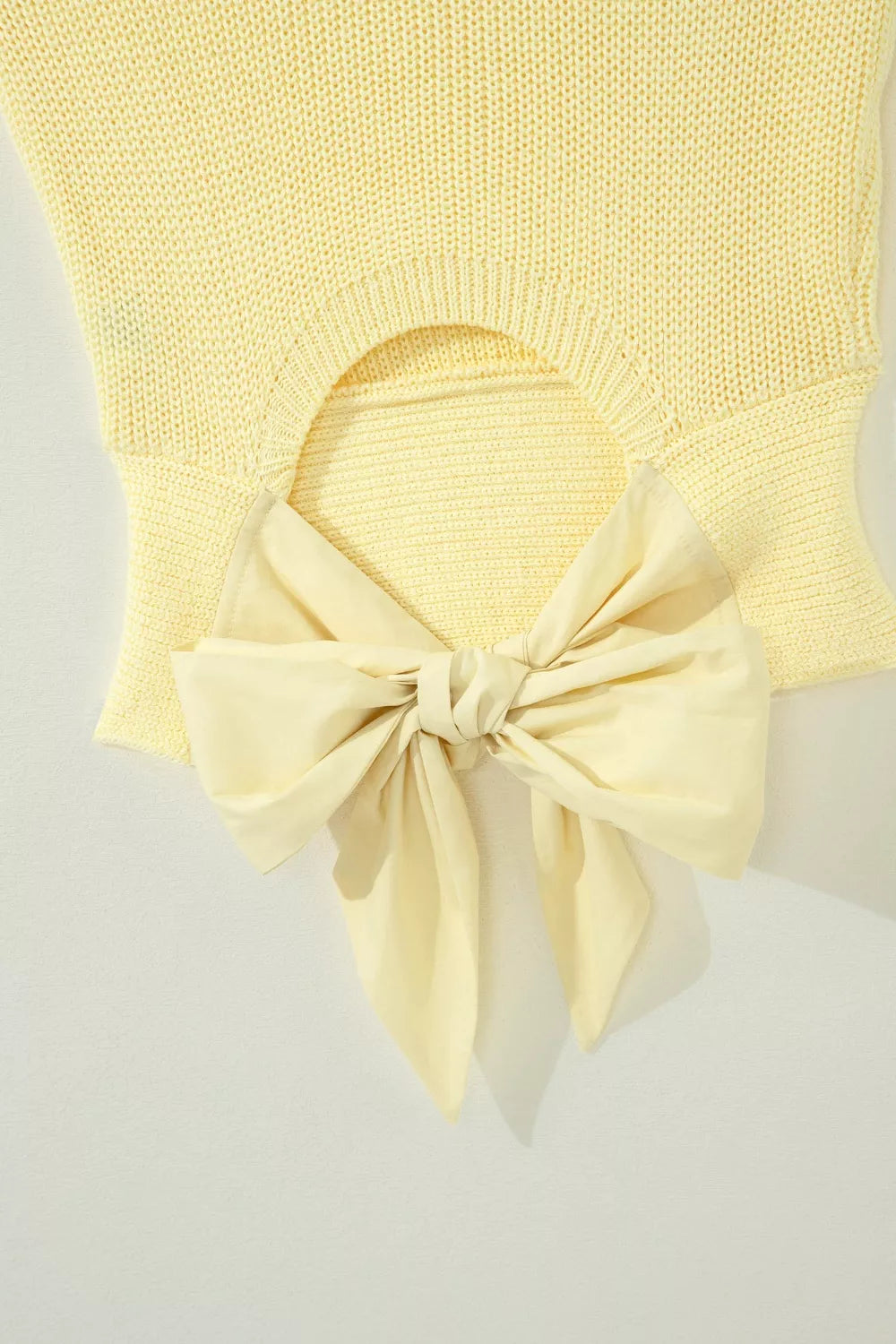 Back view of the Light Yellow Solid Color Cropped Knit Knot Back Cutout Sweater Tank, styled with polished boutique styling for day-to-night outfits, made for women who want easy layering.