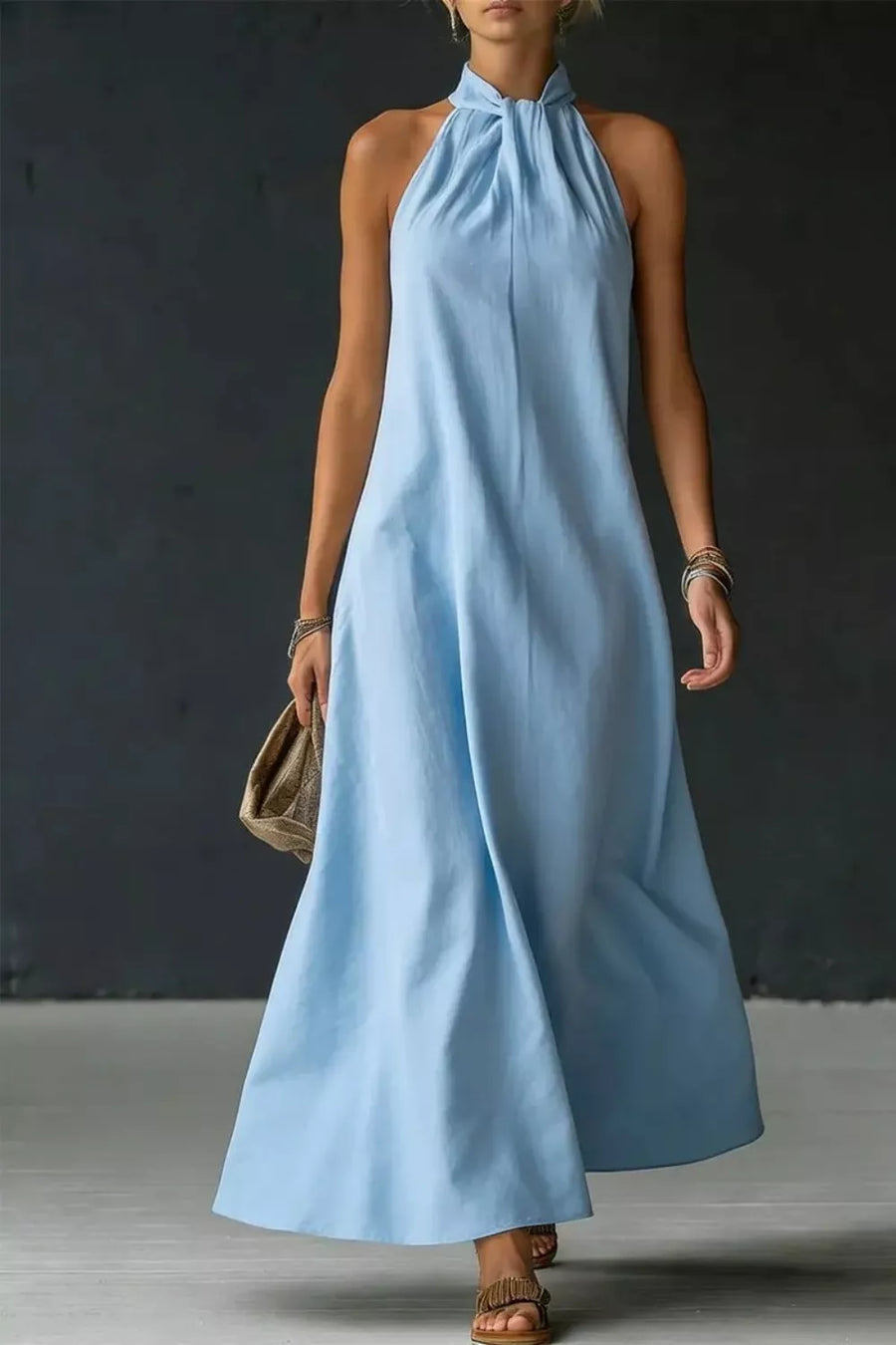 Front view of the Light Blue Halter Neck Sleeveless Maxi Dress, styled with feminine boutique styling for dinners, travel, and events, made for women who want elegant styling.