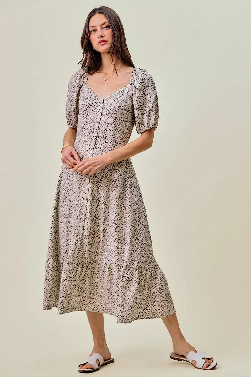 Front view of the OFF WHITE/BLACK Floral Maxi Dress, styled with feminine boutique styling for dinners, travel, and events, made for women who want elegant styling.