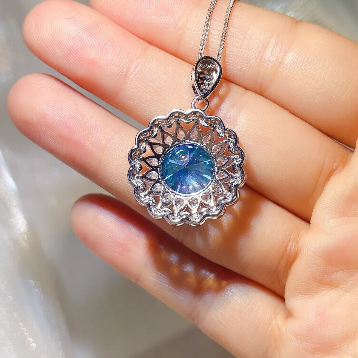 Shine detail of the Royal Blue 5 Carat 925 Sterling Silver Moissanite Pendant Necklace, styled with layered jewelry for everyday styling and gifting, made for women who want refined neckline detail.