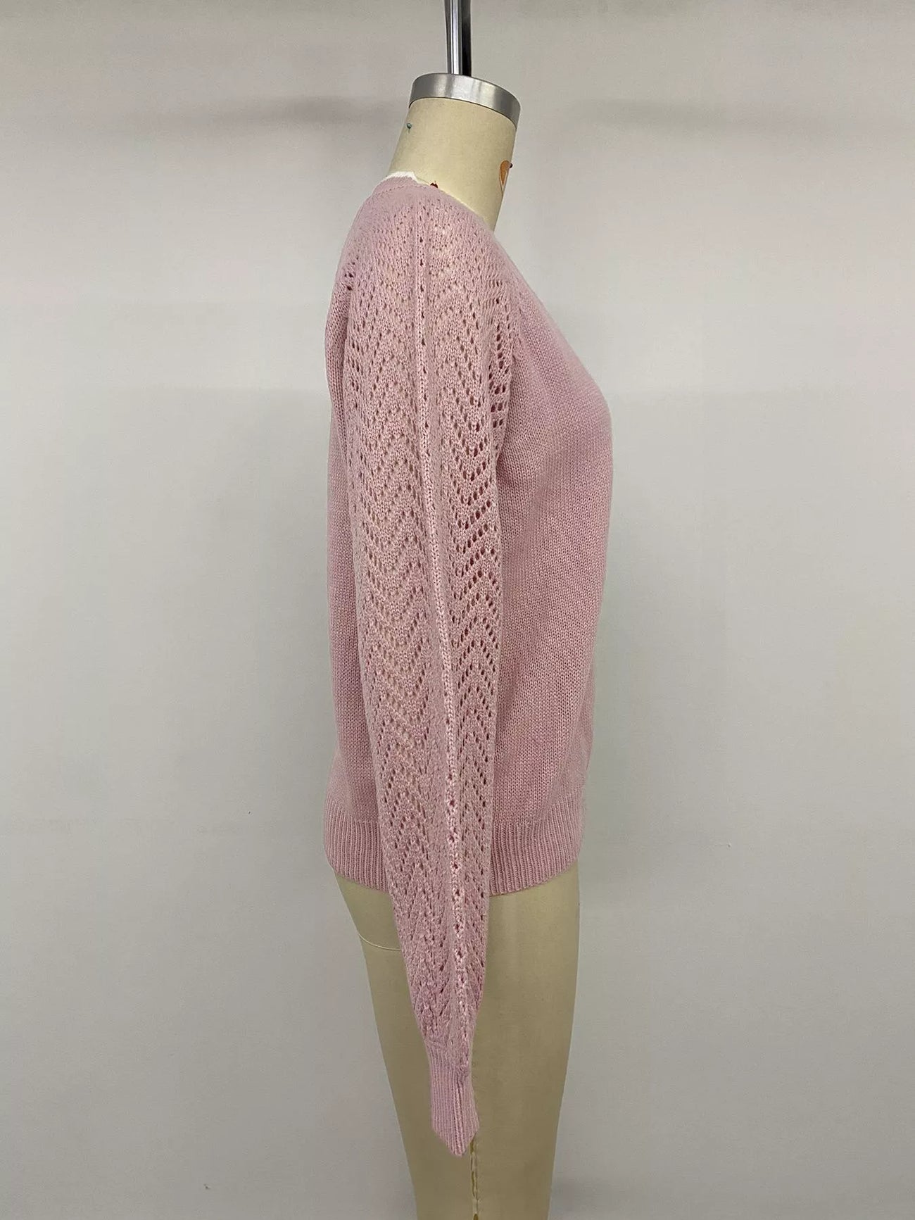 Fabric detail of the Pink V-Neck Openwork Long Sleeve Sweater, styled with polished boutique styling for day-to-night outfits, made for women who want easy layering.