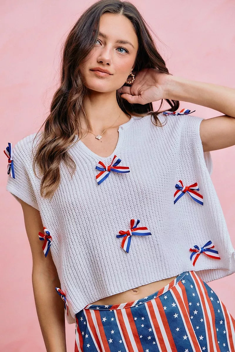 Neckline detail of the OFF WHITE SO ME 4th Of July Ribbon Trimmed Dolman Sweater Top, styled with polished boutique styling for day-to-night outfits, made for women who want easy layering.