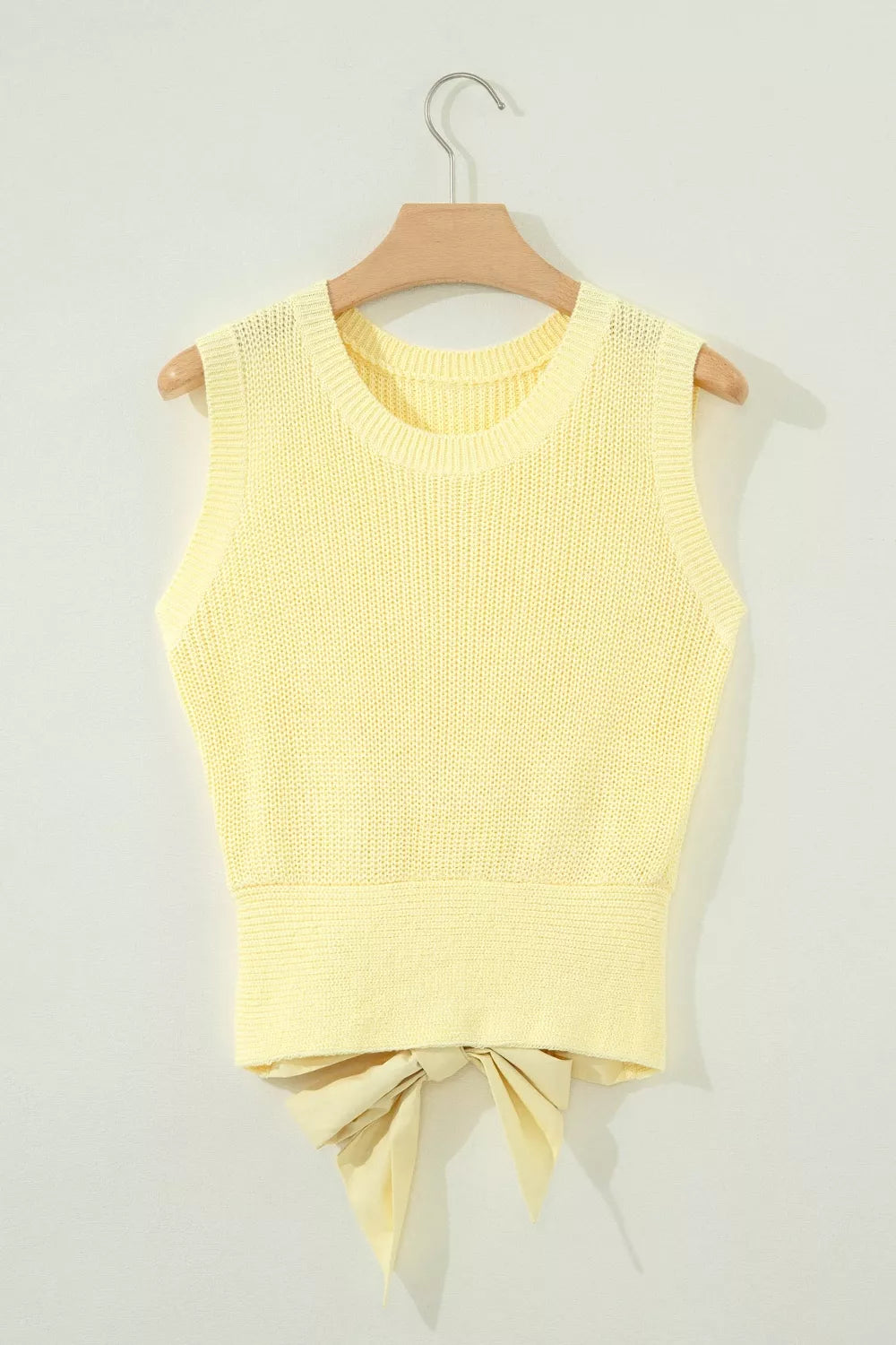 Neckline detail of the Light Yellow Solid Color Cropped Knit Knot Back Cutout Sweater Tank, styled with polished boutique styling for day-to-night outfits, made for women who want easy layering.