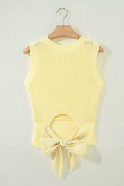 Styled outfit view of the Light Yellow Solid Color Cropped Knit Knot Back Cutout Sweater Tank, styled with polished boutique styling for day-to-night outfits, made for women who want easy layering.