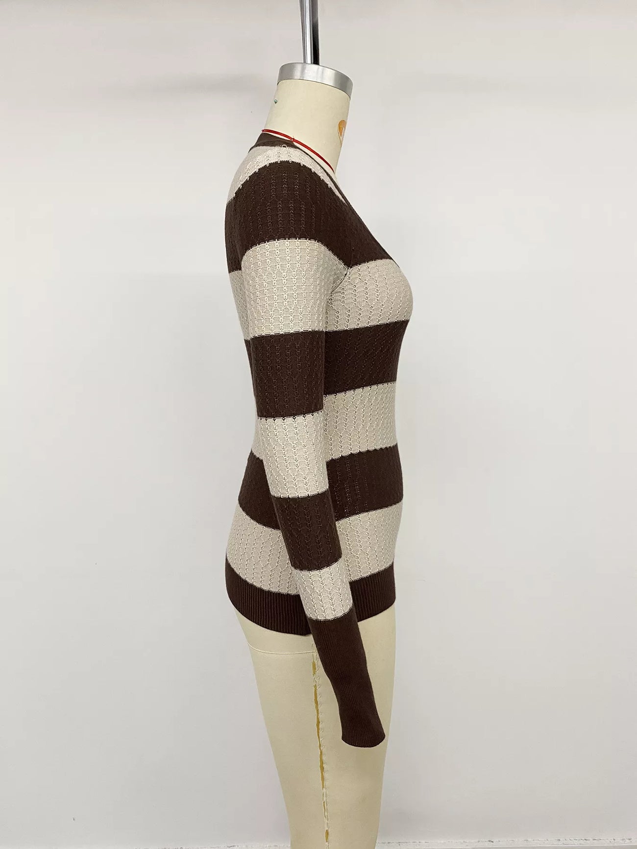 Side view of the Coffee Brown Striped V-Neck Knit Top, styled with polished boutique styling for day-to-night outfits, made for women who want easy layering.